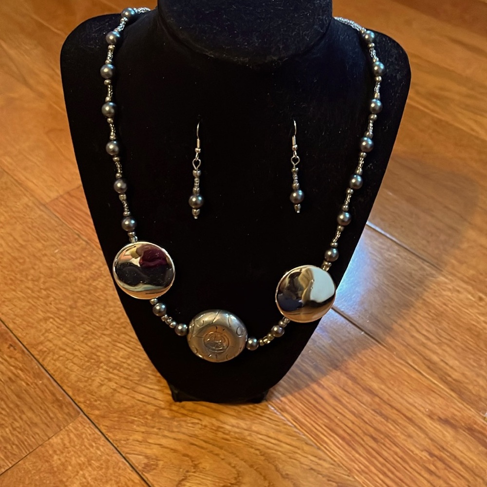 Beaded string necklace with black pearl accents and silver pendants